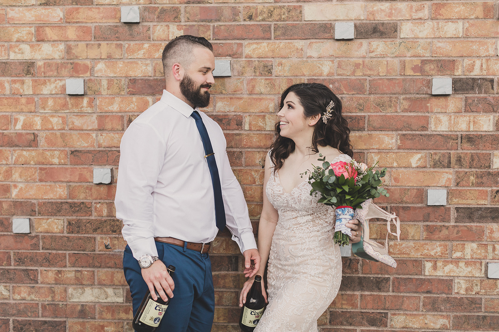 bride and groom with 40oz beers smile photographed by Taylor Made Photography