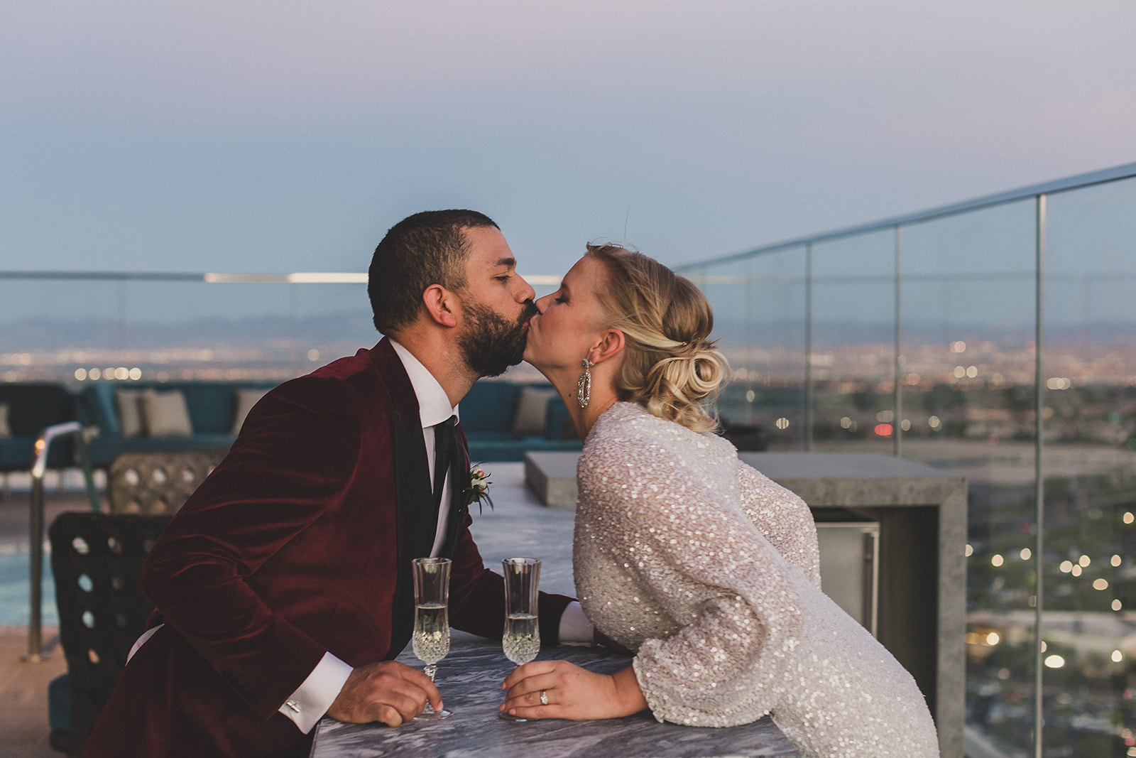 bride and groom kiss after champagne toast