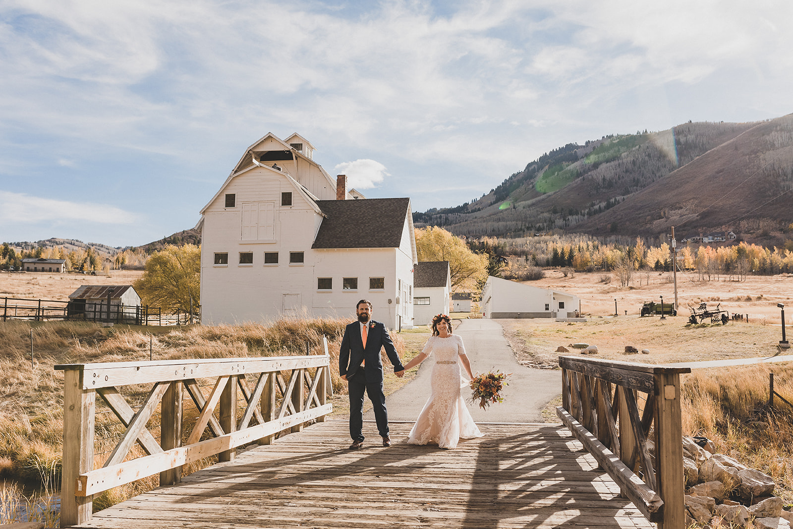 newlyweds pose on bridge in Utah