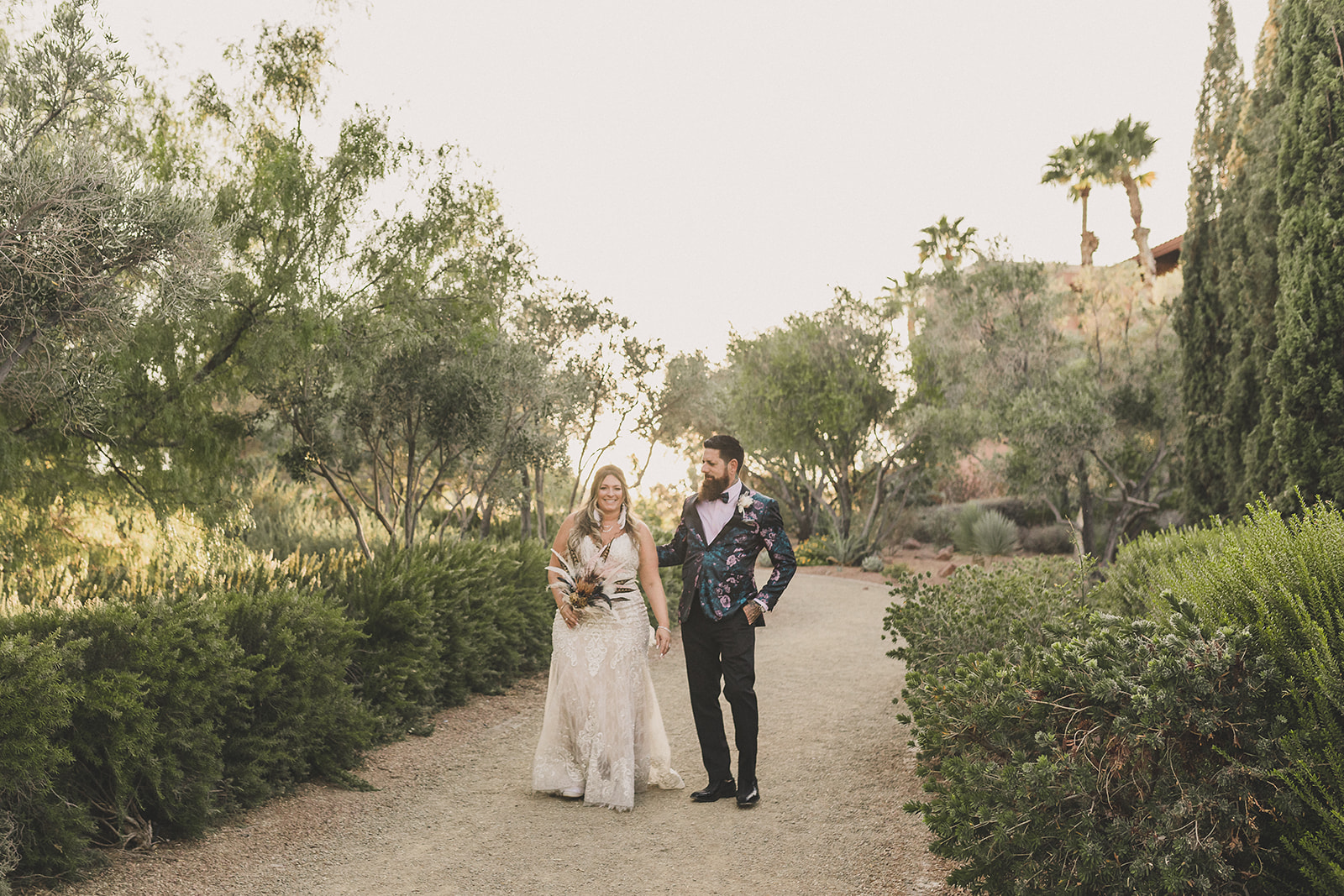 bride and groom walk on path at The Westin Lake Las Vegas